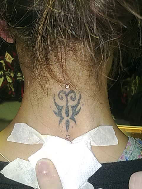 bow tattoo on back of neck. ack of the neck tattoo
